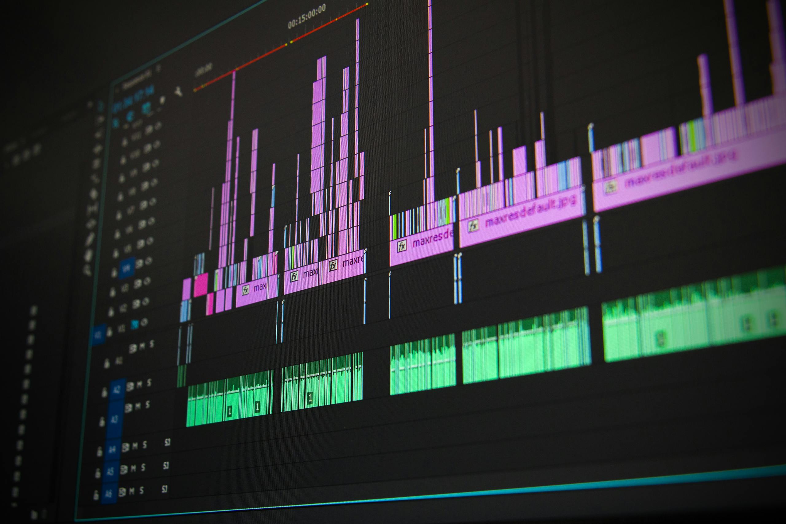 Home 7 Close-up of a professional audio and video editing software interface with waveform displays.